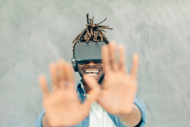 istock amazed young african american man using 3d reality on grey background 1475233680