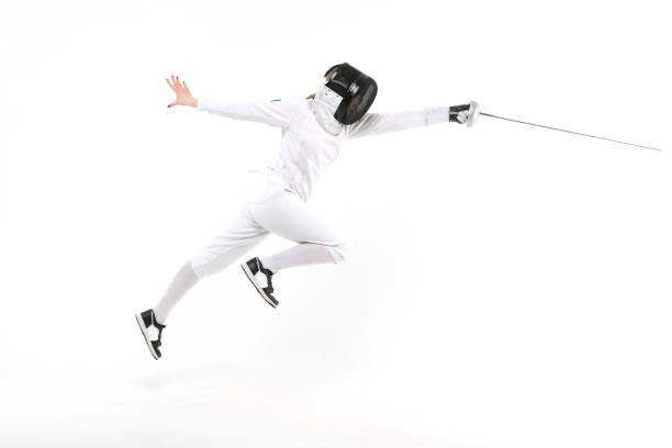 Woman in a fencing costume with a sword in hand isolated on white background