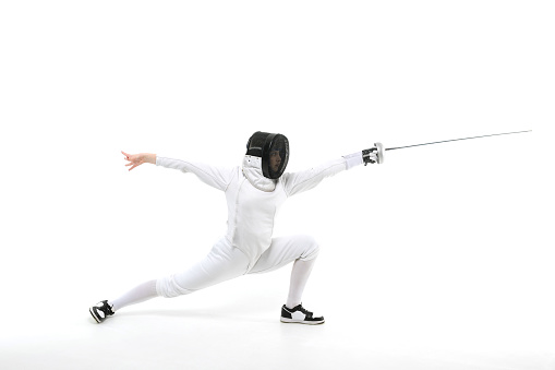 Woman in a fencing costume with a sword in hand isolated on white background