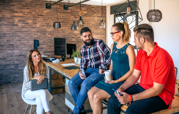 istock Office workers team talking sitting over the table in coworking 1475234927