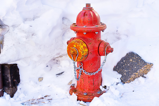Accessibility to hydrants during winter months: Vibrant red fire hydrant with cleared snow.