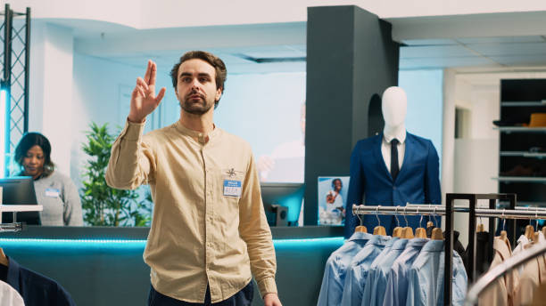 istock Clothing store assistant checking stock on hologram 1475235783