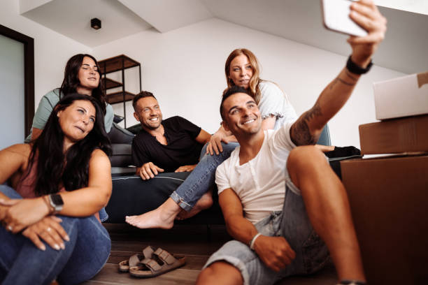 istock friends take a selfie during the moving house 1475236175