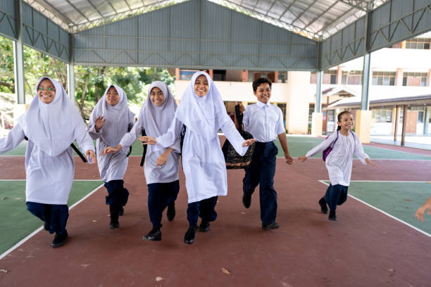 Students in school uniform racing across outdoor recreation area