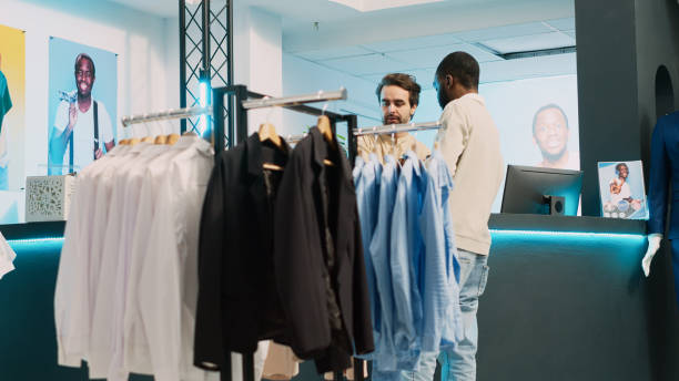 istock Male shopper paying for trendy clothes collection 1475236487