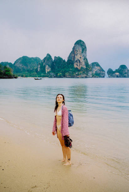 istock Woman walking on Railey beach and looking at stunning scenery 1475236520