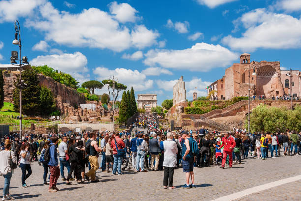 Rome, Italy - April 23, 2017: Sightseeing in Rome. Tourists in queue waiting to enter Roman Forum and Coliseum