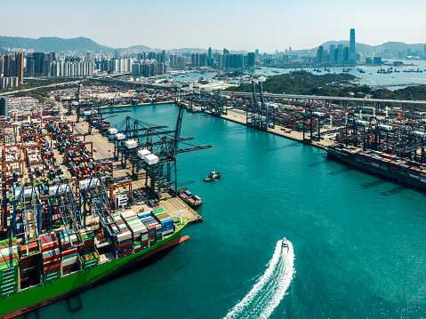 Container Cargo freight ship Terminal in Hongkong, China
Hongkong Skyline in the background