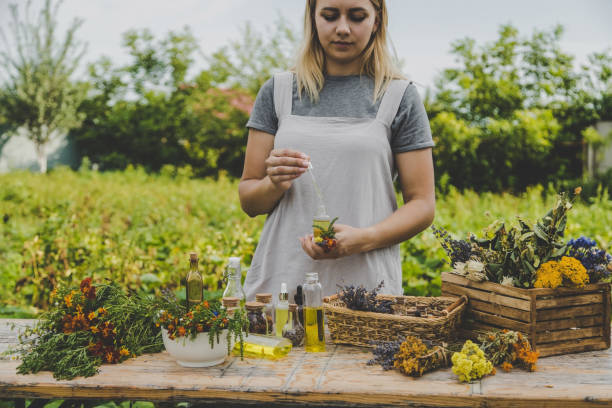 istock Woman with medicinal herbs and tinctures. Selective focus. 1475237386