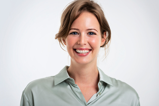 Studio headshot of attractive business woman standing at isolated white background. Copy space.