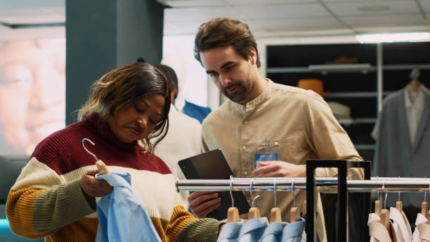 istock Retail employee helping client to choose modern clothes 1475237685