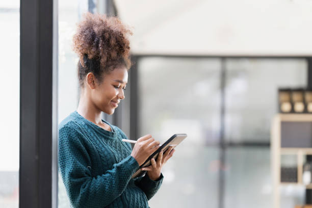 istock Beautiful young woman working using  tablet at home 1475238334
