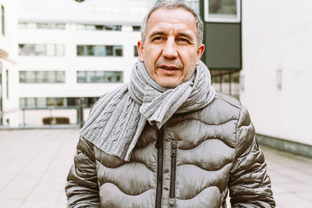 istock Portrait handsome middle-aged man in warm jacket and scarf 1475238459