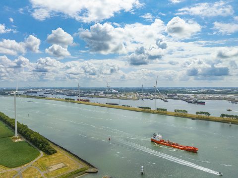 Nieuwe Waterweg canal in the port of Rotterdam with a Tanker ship for transporting chemical or oil products sailing on calm water seen from above.