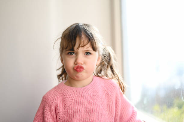 istock Playful child looking at camera and making a face. 1475240107