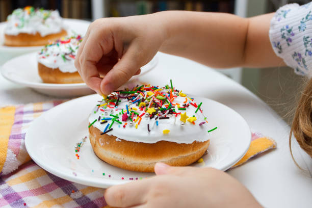 istock Process of decorating a cake with sweet colored decorations 1475243270