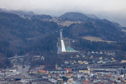 Innsbruck, Austria - February 26, 2023: Aerial view of city and Bergisel Ski Jump, facility of FIS World Cup in ski jumping. It is the venue of annual Four Hills Tournament competition