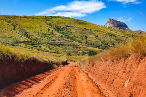 Red dust and mud road in poor condition with ridges formed after rain. Routes to Andringitra national park are bad during wet season in region near Ambalavao, Madagascar stock photo