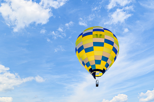 Colorful hot air balloon flying over blue sky