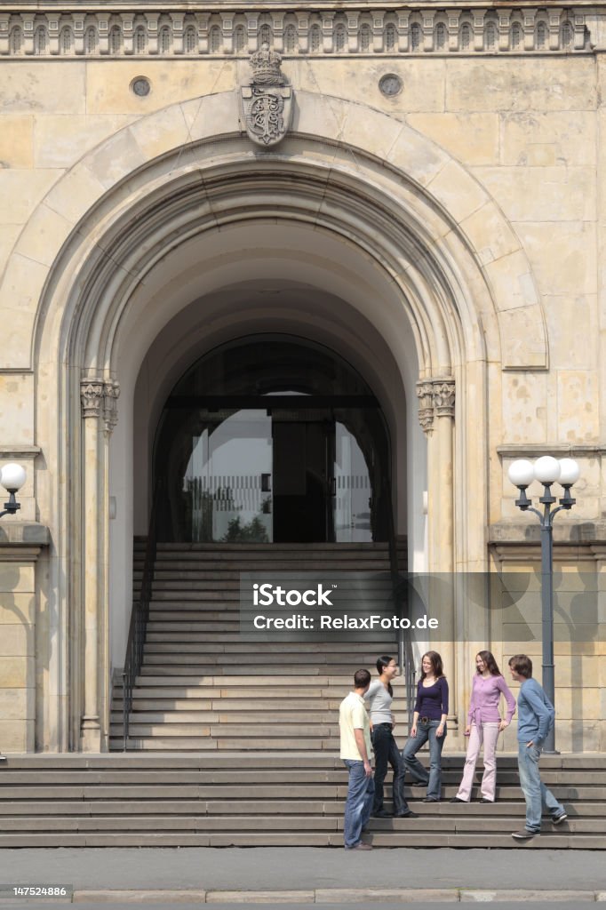 Group of Students in discussion standing on staircase (XXXL) Group of students (three female, two male) on staircase of old university in Hannover, Germany. Clique Stock Photo