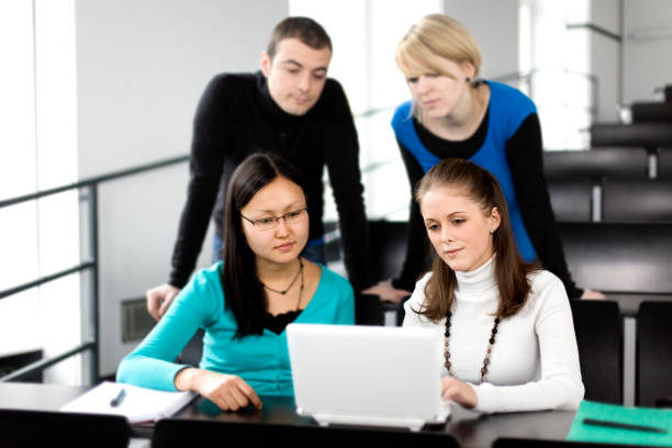 istock Group of students working with laptop in lecture hall (XXXL) 147524986