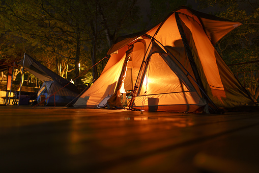 Lighted tent in the wild at night