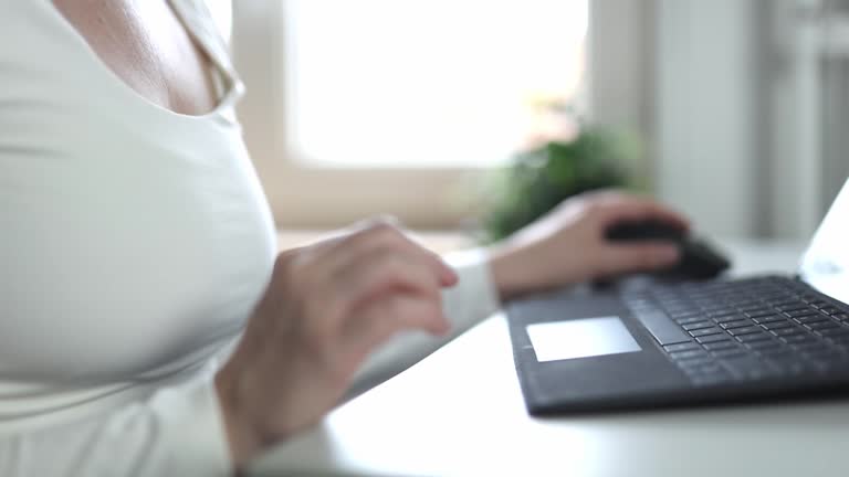 Female hands of business woman professional user worker using typing on laptop notebook keyboard sit at home office desk working online with pc software apps technology concept, close up side view