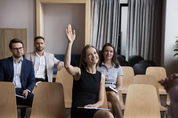 istock Woman employee, training participant having question raise arm during workshop 1475257223