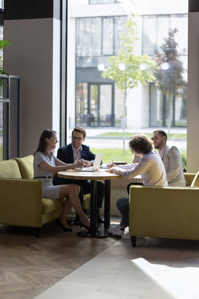 istock Businesspeople sit in modern office laughing, brainstorm, discuss business 1475257985