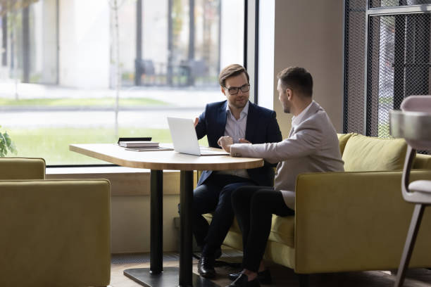 istock In modern office two businessmen engaged in teamwork using laptop 1475257990