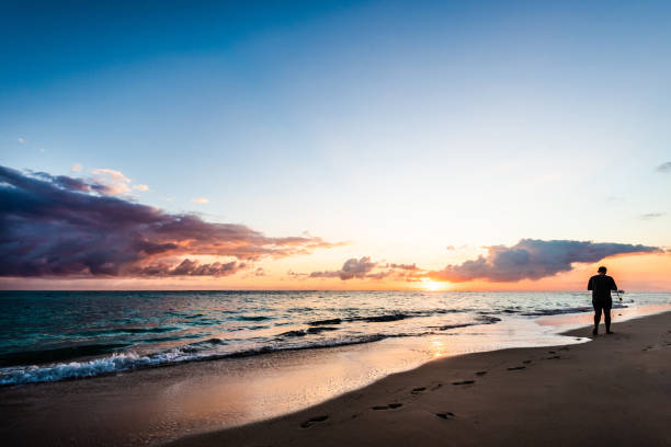 istock Walking on the beach at sunrise 1475262675