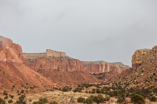 Stunning red rock mountain valley in the high desert of rural New Mexico with overcast sky