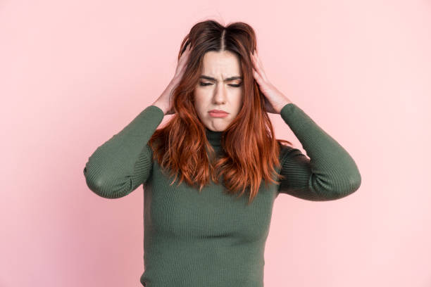 istock Young woman touching hair with headache 1475263756
