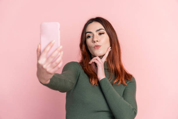 istock woman taking selfie on smartphone 1475264934