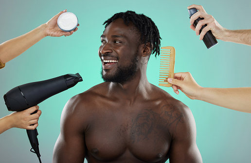 Hair, makeover and man in studio salon with smile, hairdryer and comb on green background. Beauty, haircare treatment and product for happy male model with natural hairstyle at barber or hairdresser.
