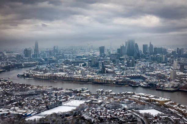 Panoramic view of the London skyline during a winter day with low clouds and snow, England