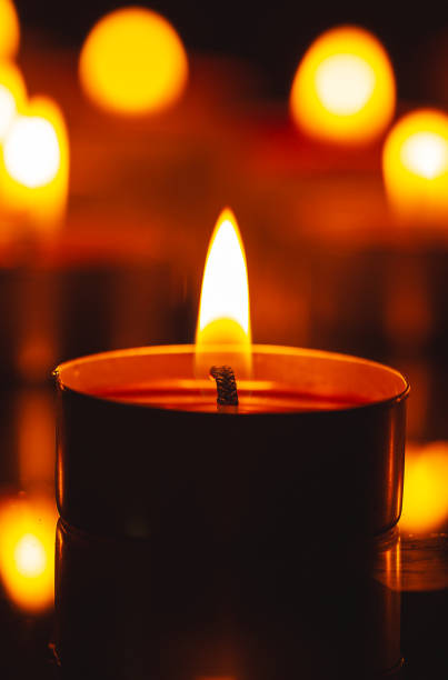 istock macro candle,Burning candles on a dark memorial day surface 1475267392