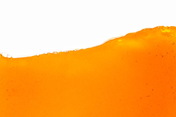 istock orange juice isolated white background,orange juice texture on white background,Close up bright orange juice texture for health and nature waves 1475267431