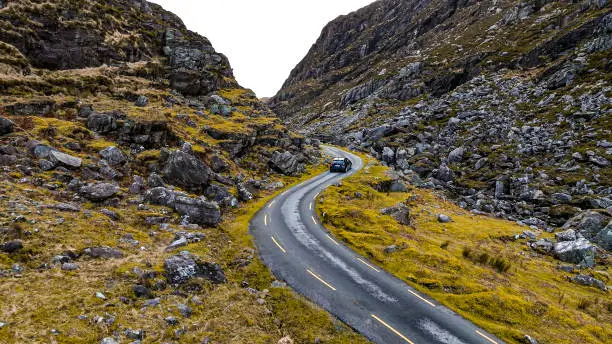 Photo of Aerial view of Gap of Dunloe, County Kerry in Ireland,Aerial view of scenic mountain pass, aerial nature and road view, aerial view of winding road, nature relax video, car driving the winding road between the mountain