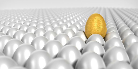 Golden egg is surrounded by bunch of white eggs and standing out from the crowd. Easter, standing out from the crowd, business, teamwork and individuality concept. Easy to crop for all social media and print design sizes.