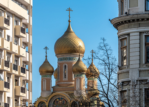 Moscow downtown cityscape. Kremlin Towers, Ivan the Great Bell Tower, Dormition Cathedral in spring day. Majestic domes.Road is filled out buy cars. Rush hours