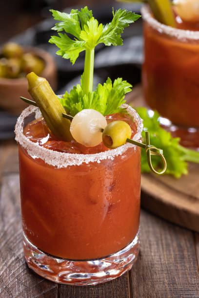 istock Bloody mary cocktail with garnishes on rustic wooden table 1475270067