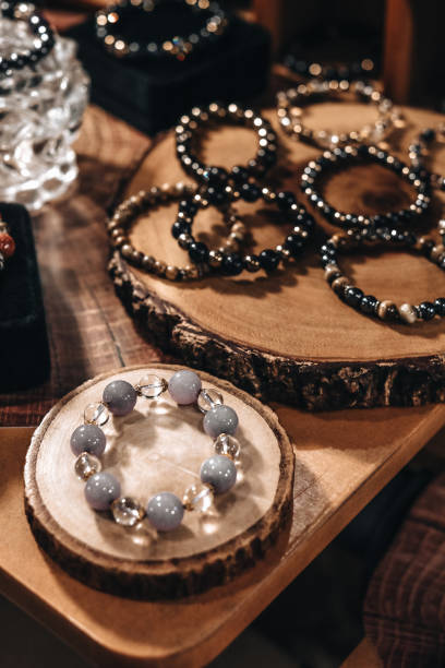 istock Bracelets stone beads on a natural wood stand 1475272799