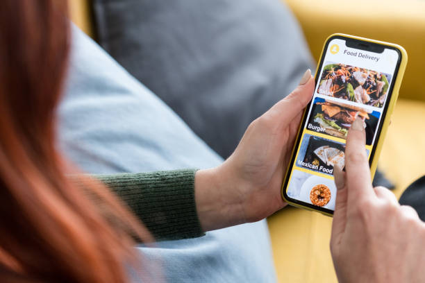 istock Crop faceless woman using smartphone ordering food online 1475272909