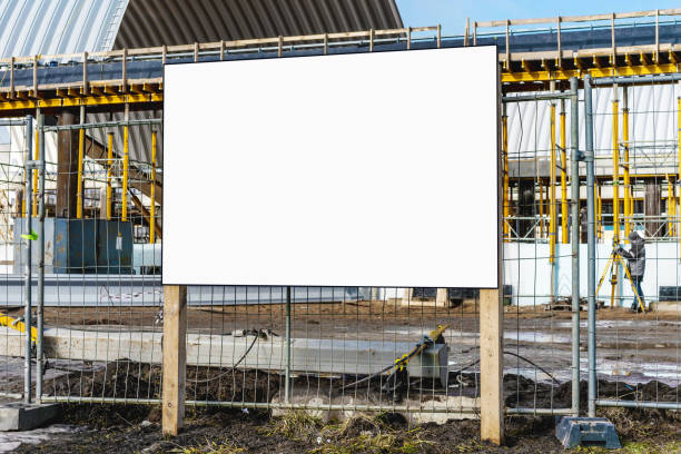 White information sign board on wooden poles on construction site White information sign board on wooden poles on construction site at urban street outside. Housebuilding and development concept. construction zone signs stock pictures, royalty-free photos & images