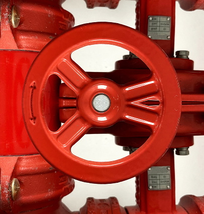 Red stopcock. Water Valve with words Open and Shut and arrows