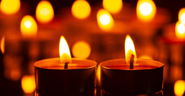 istock macro candle,Burning candles on a dark memorial day surface 1475274605
