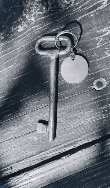 istock Old key with blank tag wooden background. Space for text. Rustic texture. Retro style. Vintage object. Black and white photo 1475274610