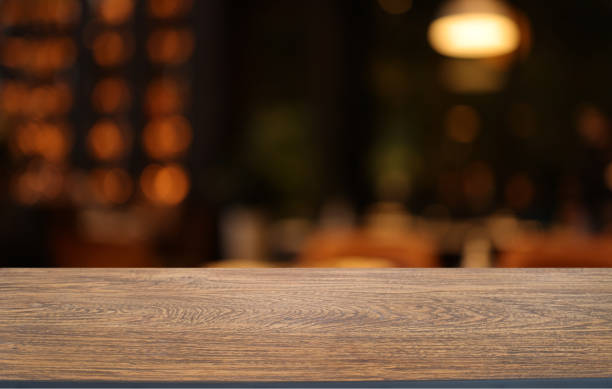istock Wood table top in front of abstract blurred background. Empty wooden table space for text marketing promotion. blank wood table surface copy space 1475276253