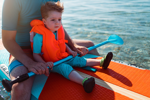 Father and son on a paddleboard.